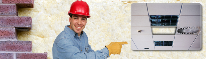 left part of brick wall middle smiling builder pointing at device right